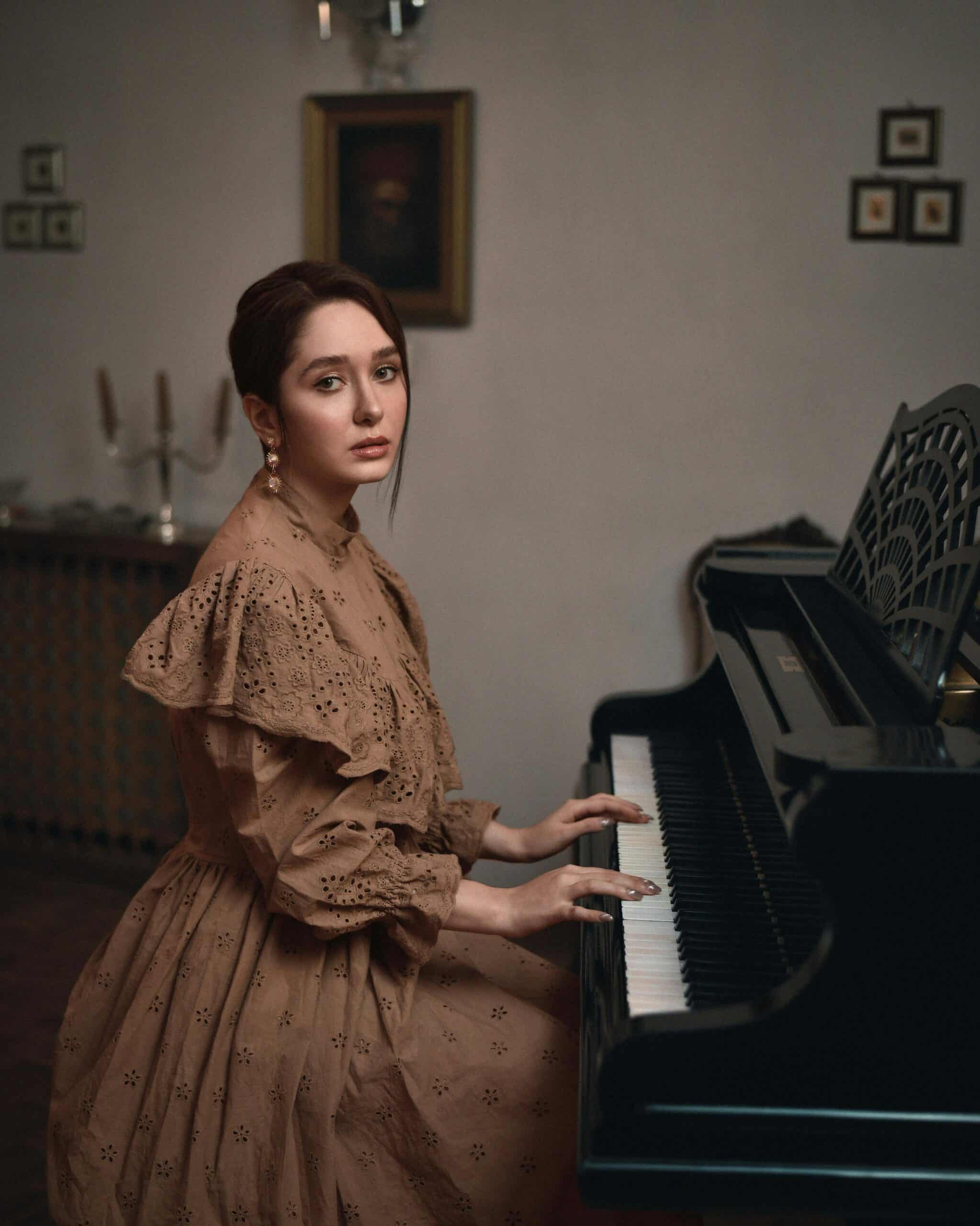 A woman in a brown dress looking at the camera