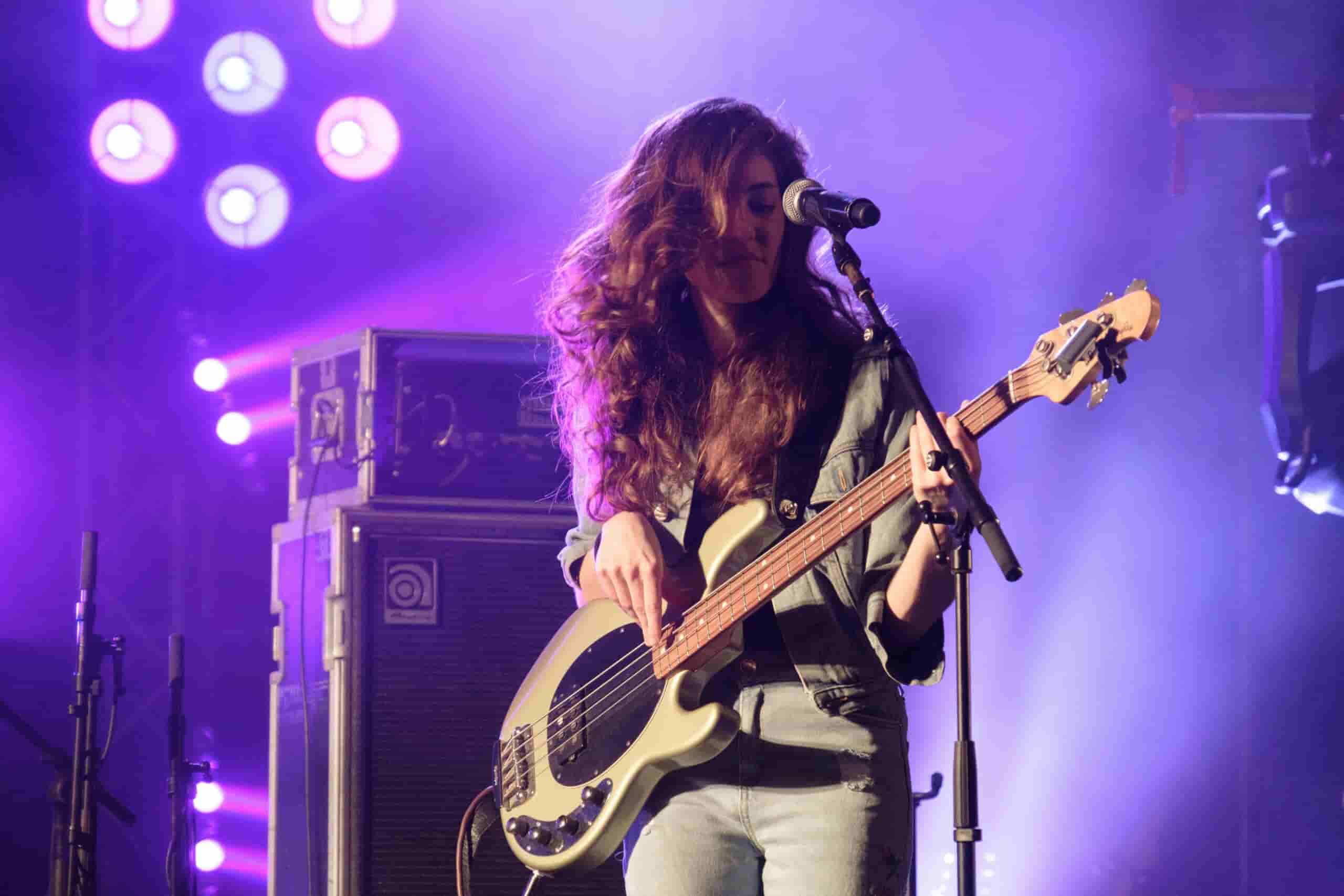 Woman on stage playing bass guitar