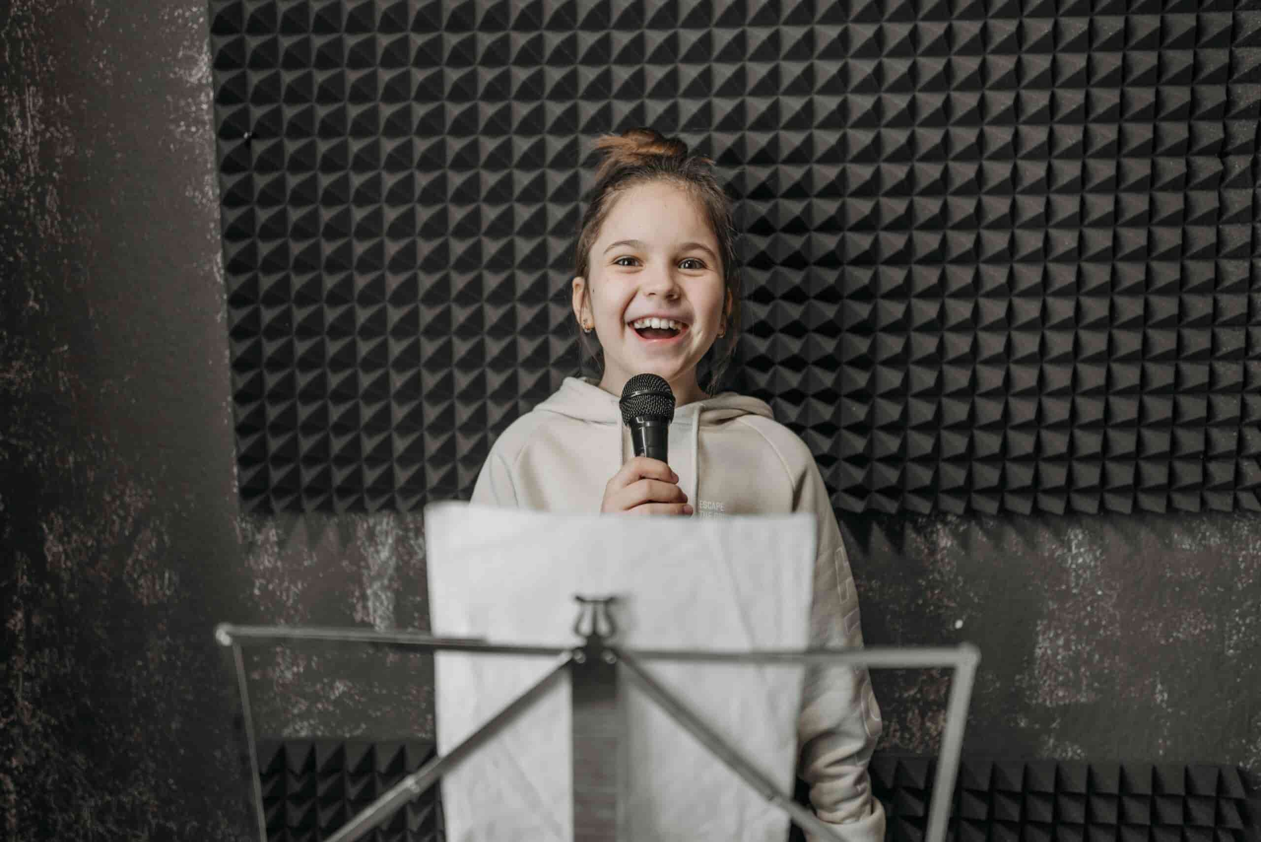 Girl taking singing lessons, singing with a happy expression.
