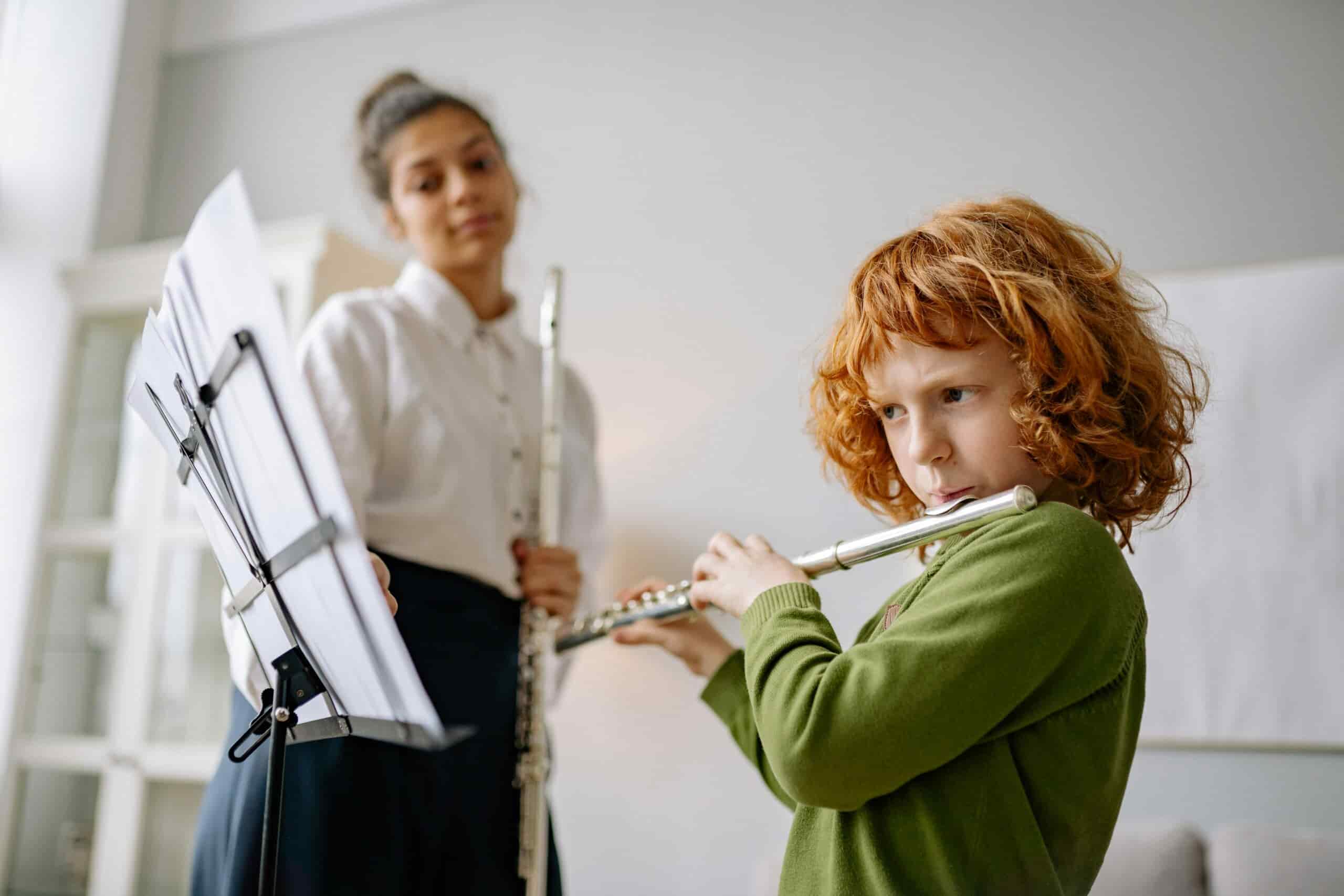 Landscape image of a kid taking flute lessons