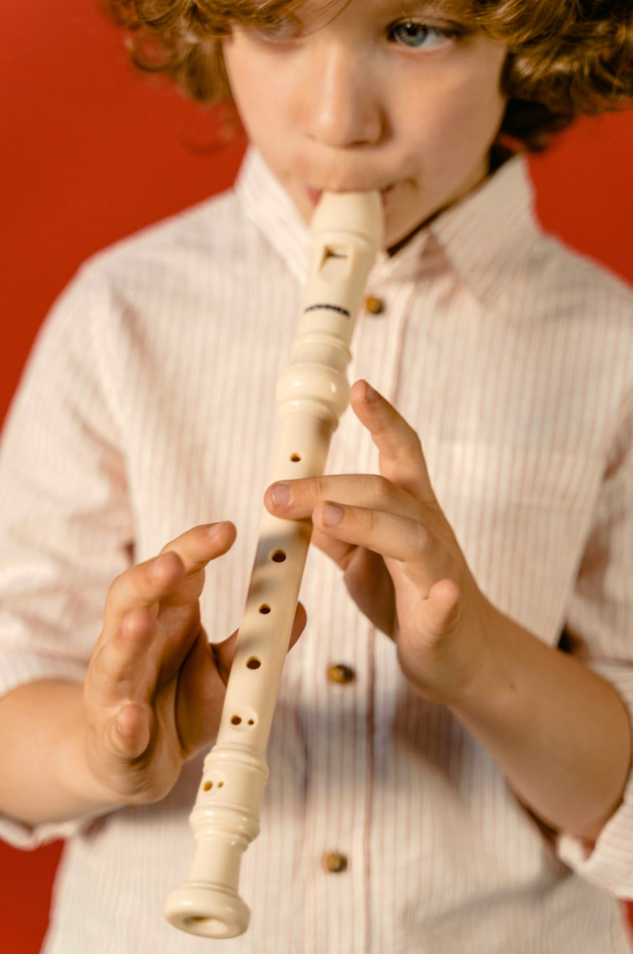 Kid playing recorder close up of hand position