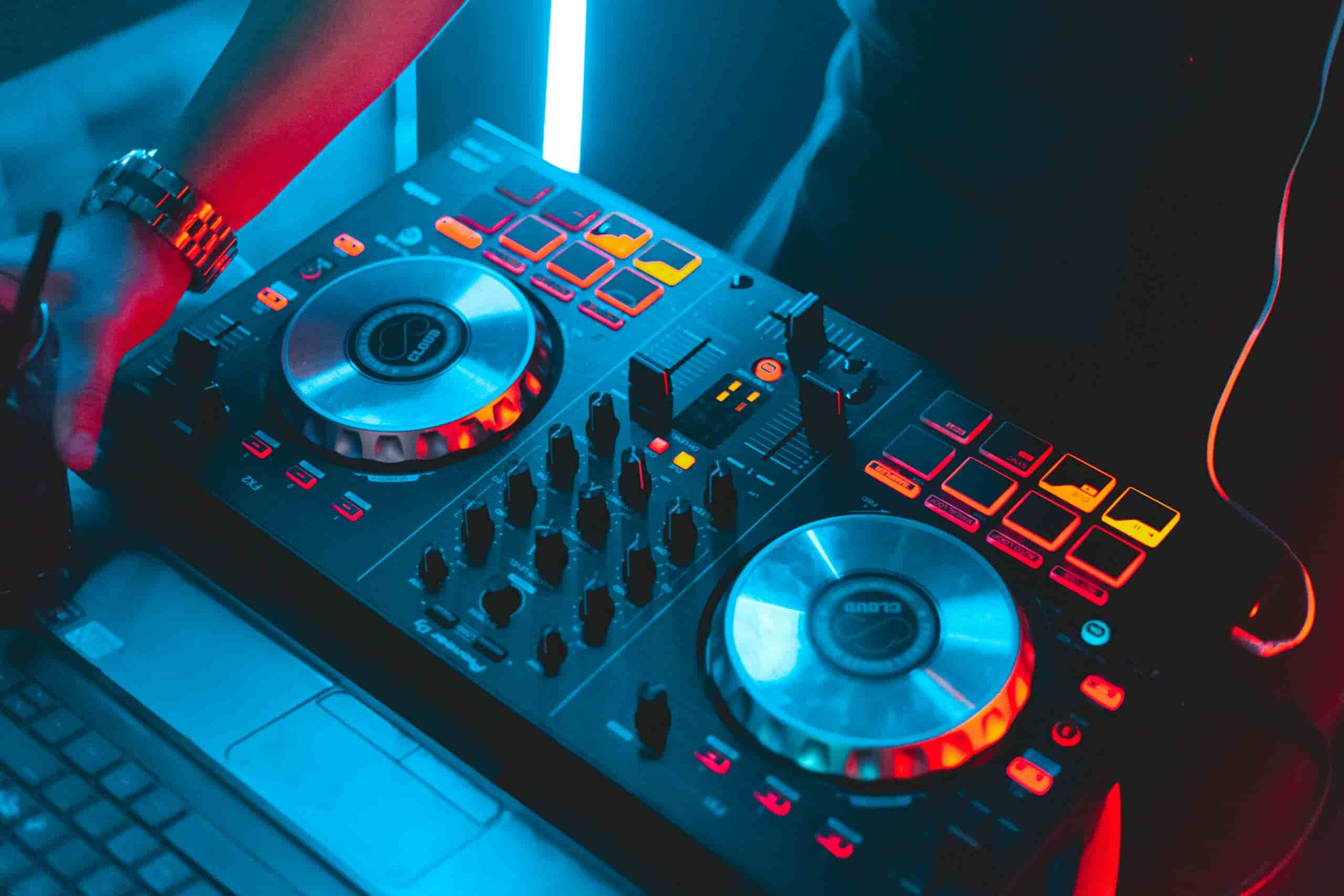 Man watching DJ lessons and DJing - close up shot of the deck