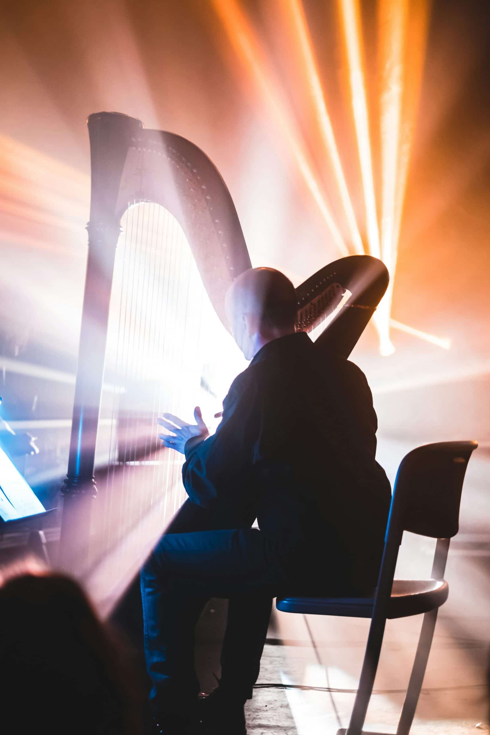 Man with harp and beaming light