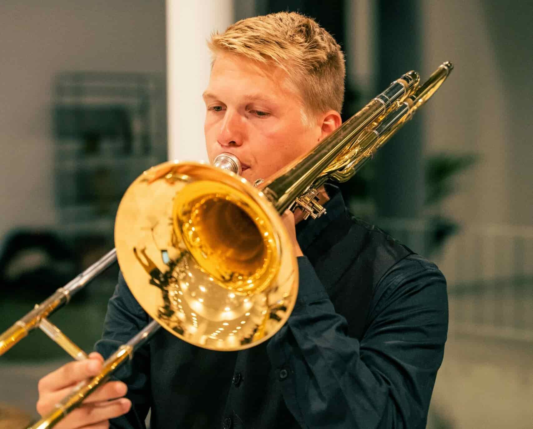 Man taking trombone lessons playing the trombone