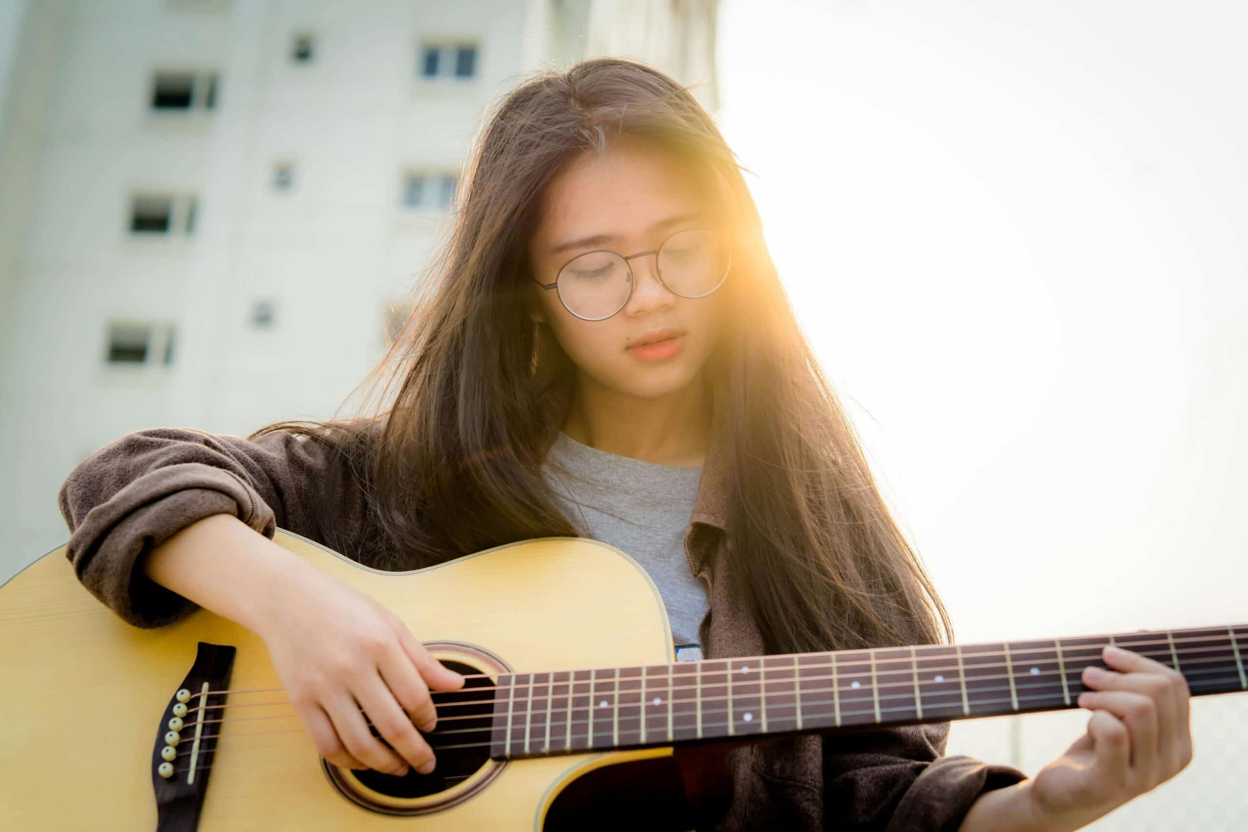 Girl playing acoustic guitar