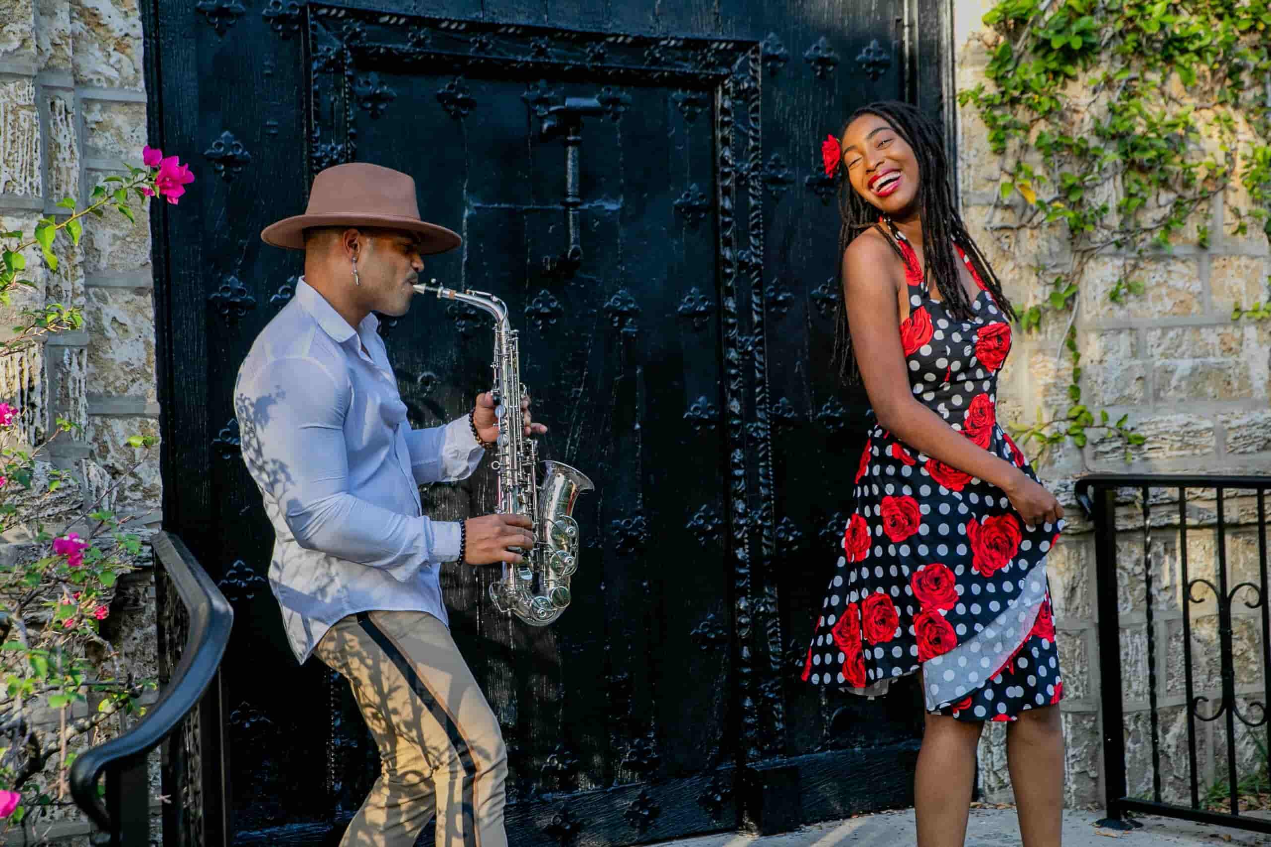 Man playing saxophone for woman