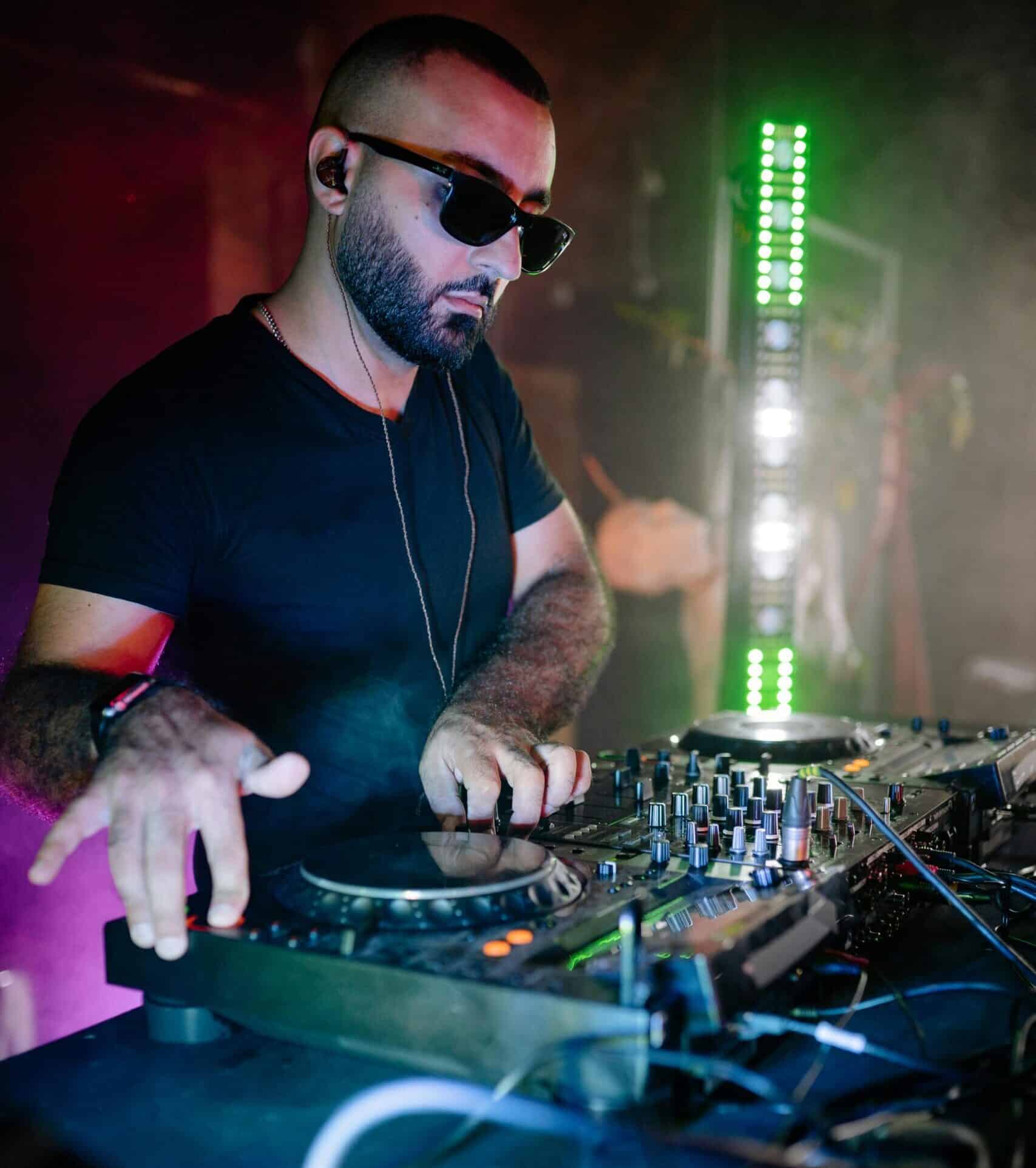DJ with glasses and casual expression
