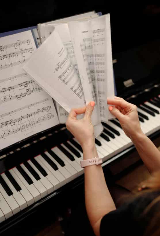 Piano accompanist flipping through notes