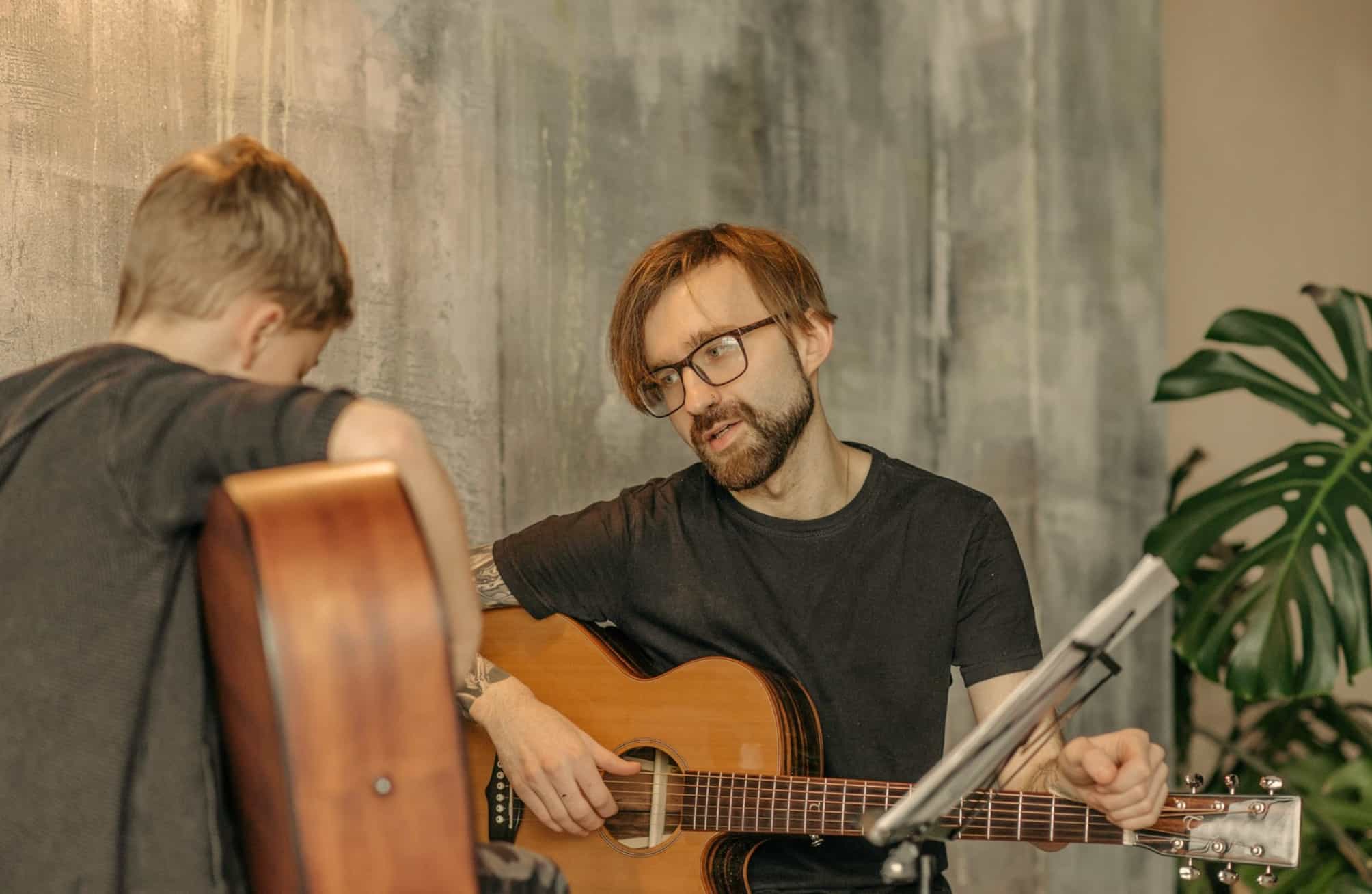 Guitar lessons with man and a boy