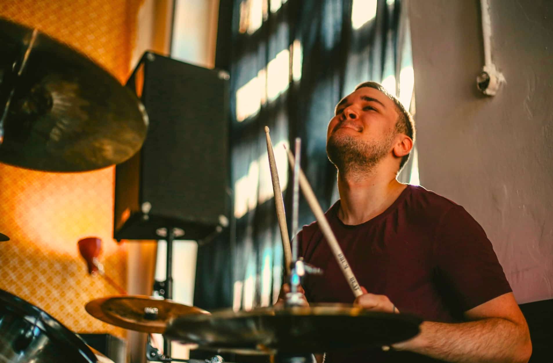 Drummer in the studio wit his head up
