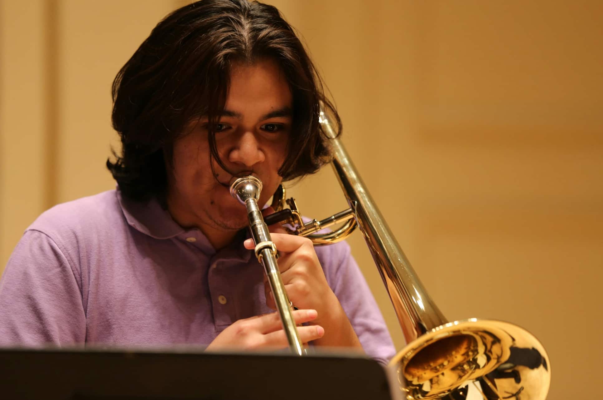 Man playing trombone in trombone lessons