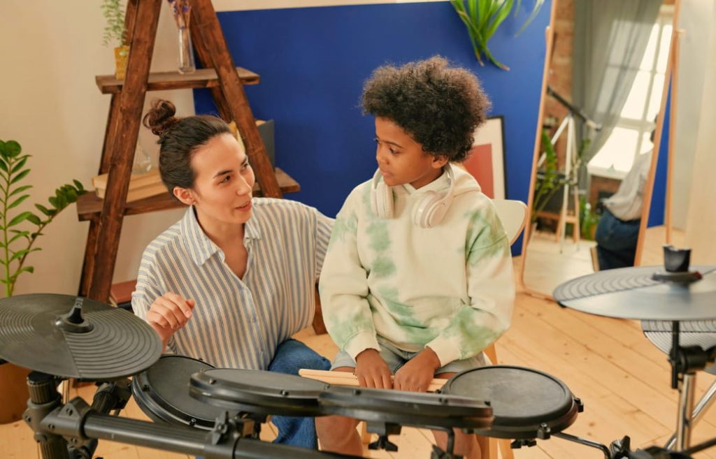 Drum student in drum lessons with drum kit teacher