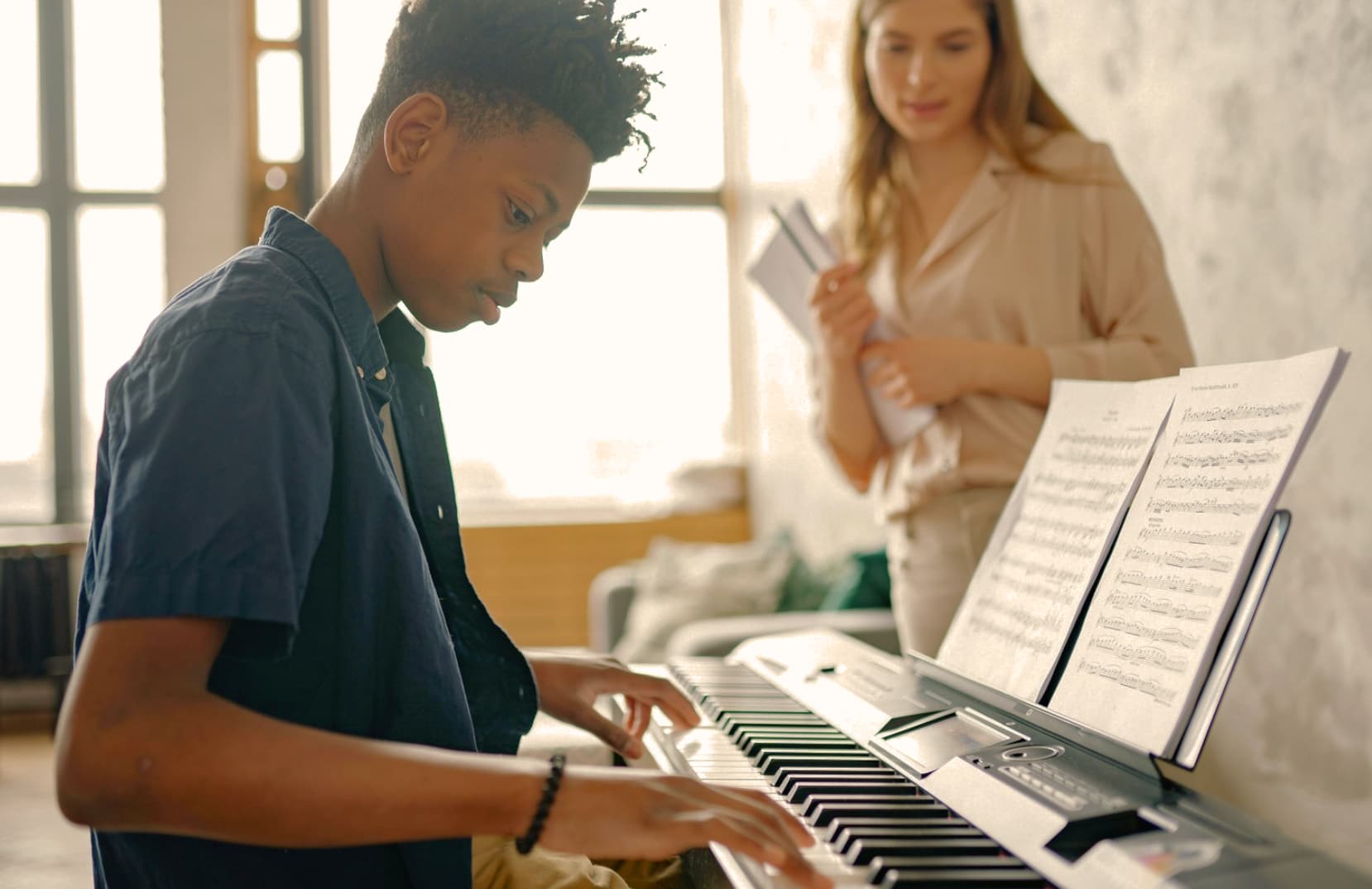 Piano student in piano lessons with piano teacer