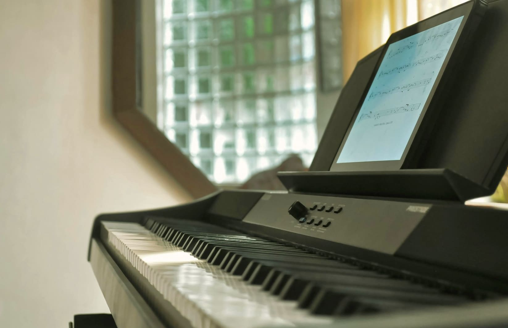 Digital piano with ipad showing sheet music