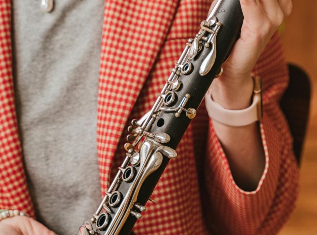 Teacher holding a clarinet to show viewer
