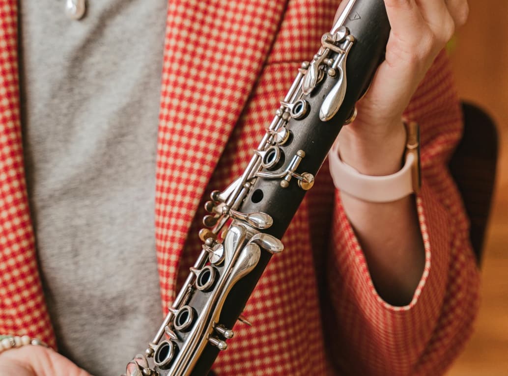 Teacher holding a clarinet to show viewer