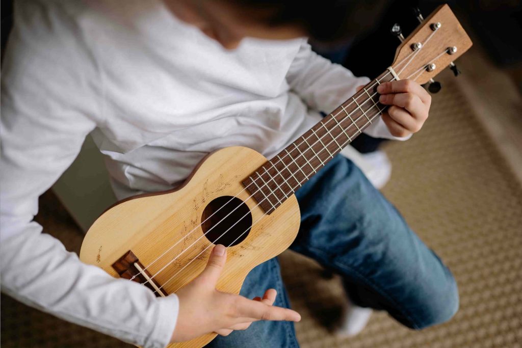 boy-playing-ukulele-during-lessons