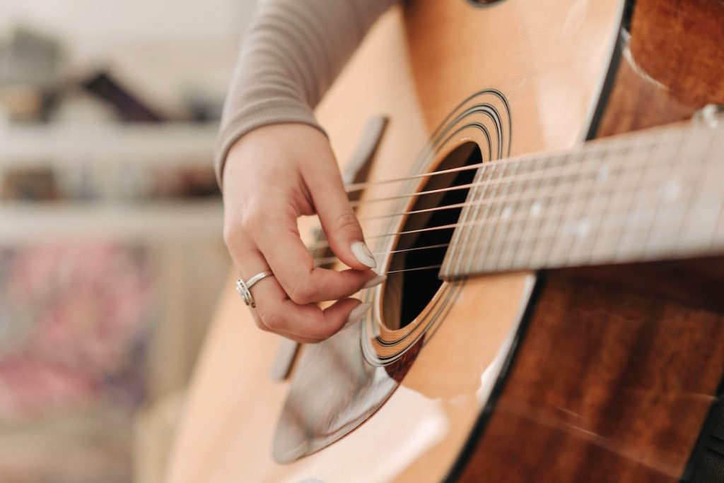 Girl taking guitar lessons