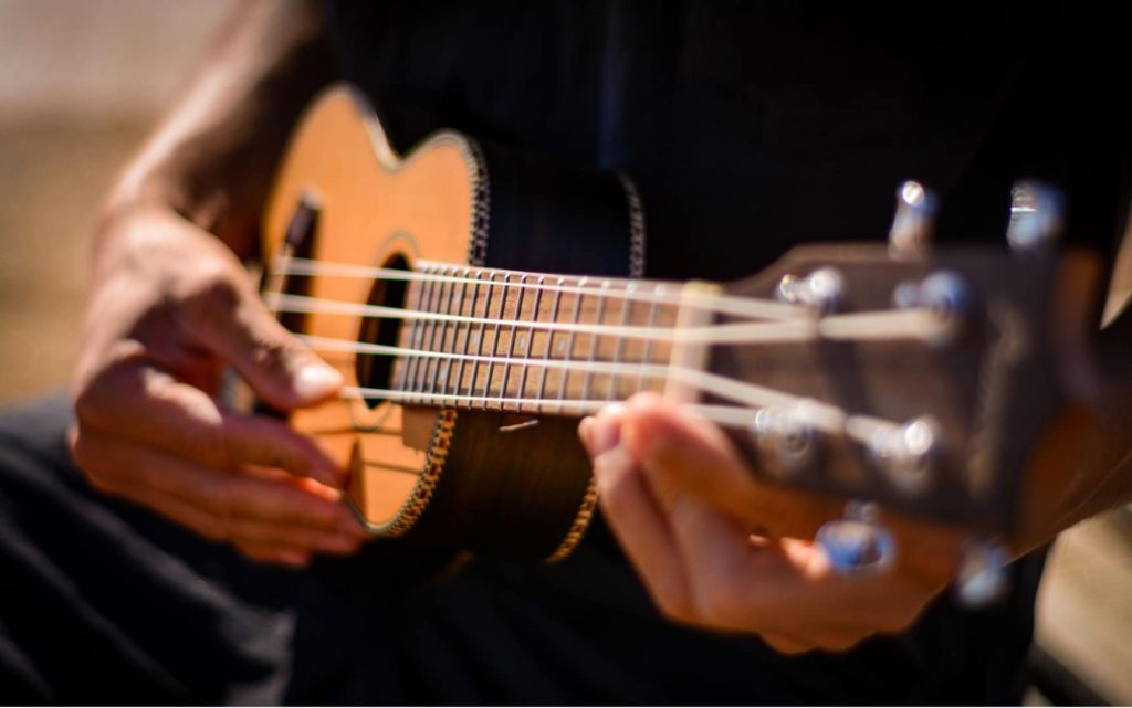 Close-up of a ukulele being played by a beginner musician