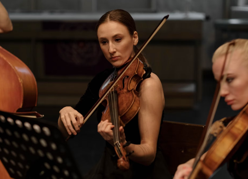Two young musicians playing violin and viola in an orchestra
