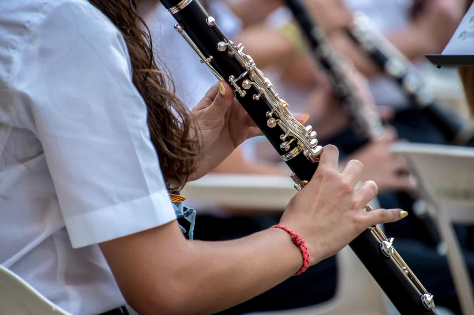 Close-up of a musician playing an oboe during a music performance.