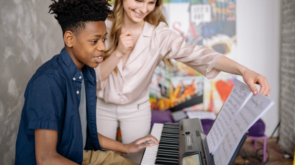 Piano and brain development: teacher guiding a young student