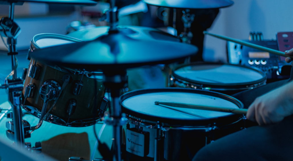 A beginner playing a Roland electronic drum kit