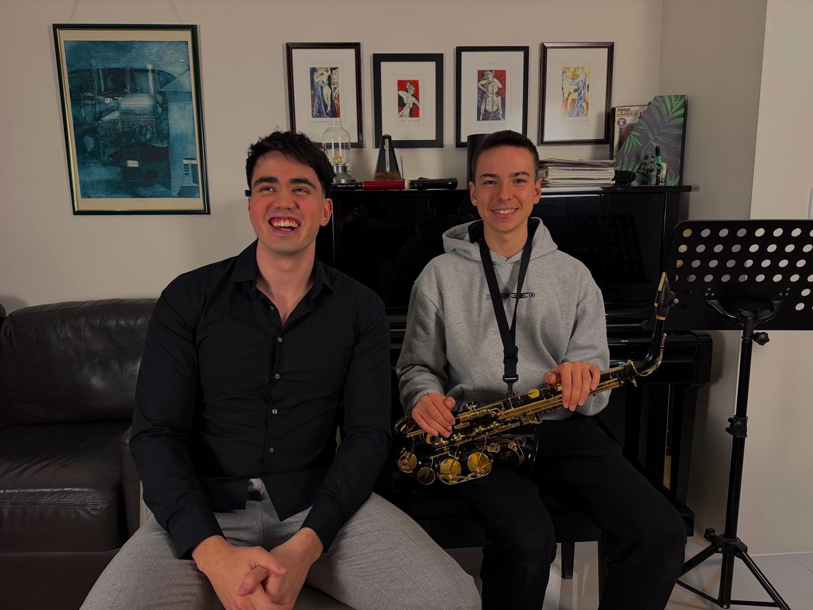 Luka Petrovic and a saxophone student smiling after a lesson