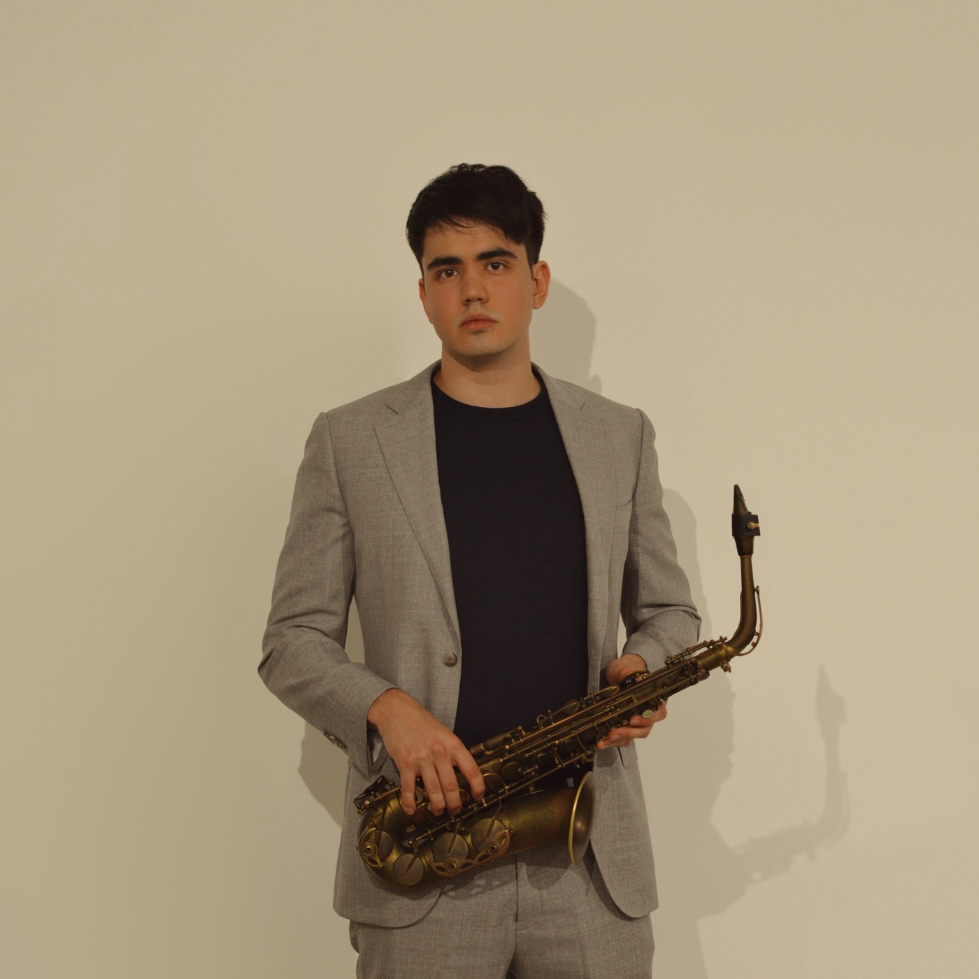 Luka Petrovic, founder of Sydney Music Lessons, holding his saxophone